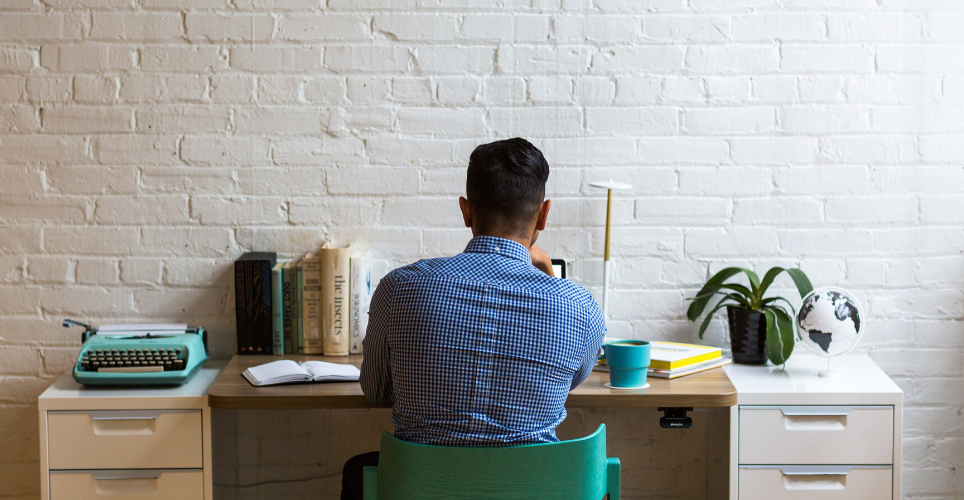 Man sitting at desk with laptop