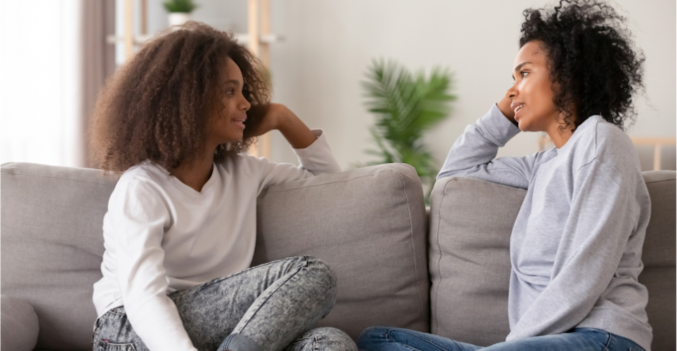 mom talking to daughter who has a slight side eye look of uncertainty. 