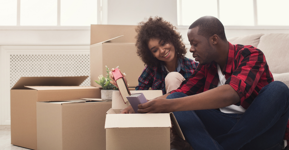 Man and women unpacking boxes in new home