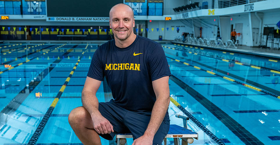 Matt Bowe, U-M swim coach, sitting by the pool