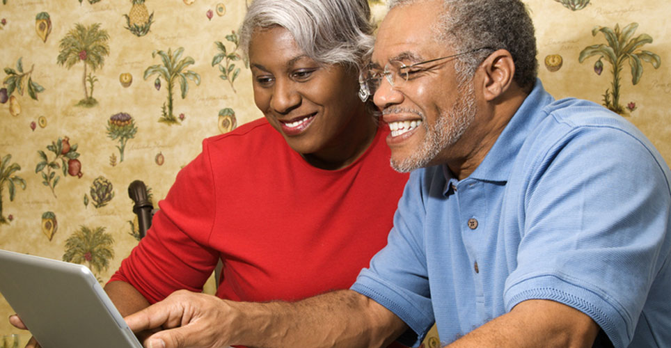 man and women looking at a laptop screen