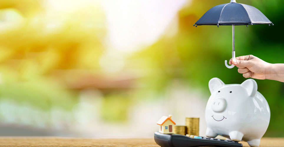 piggy bank with someone holding an umbrella over it.