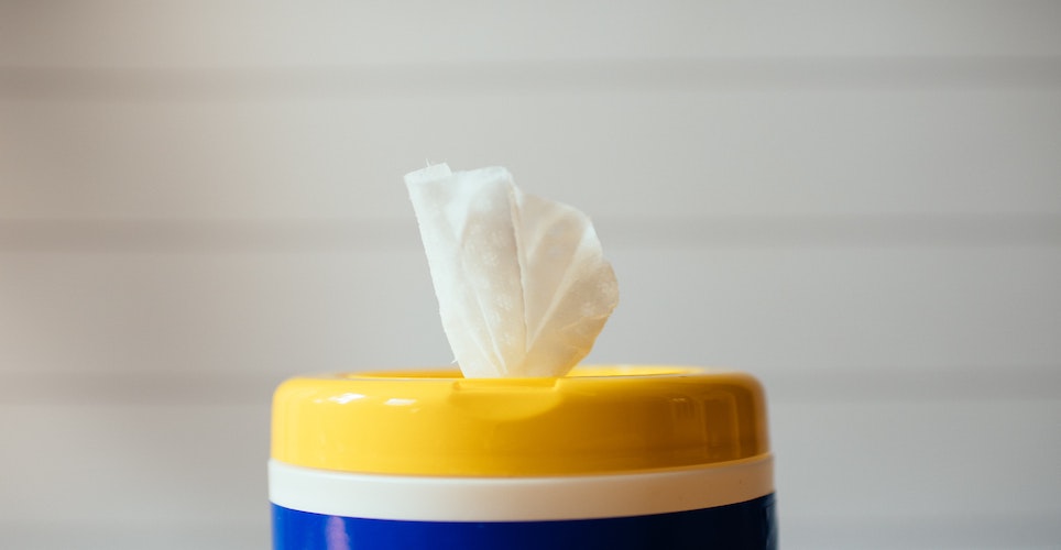 yellow blue and white plastic container of disinfectant wipes