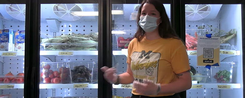 woman standing in front of refrigerators