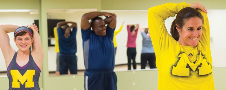 3 people with arms over their heads stretching