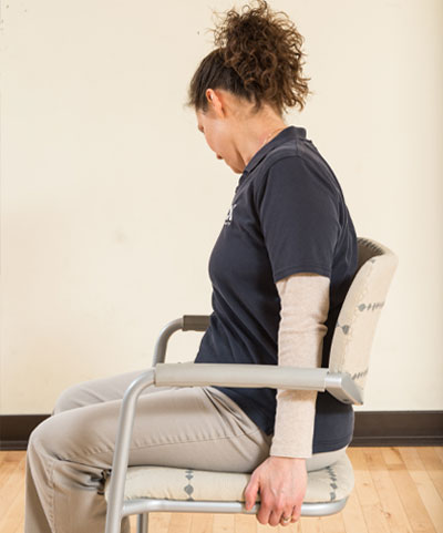 woman sitting in chair - head looking down