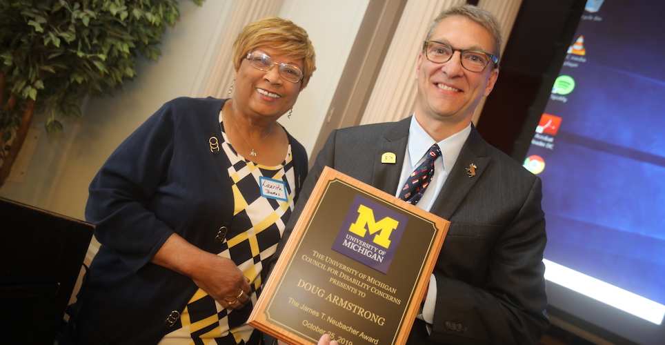 Former AVP of HR Laurita Thomas presents the 2019 James T. Neubacher Award to Doug Armstrong.