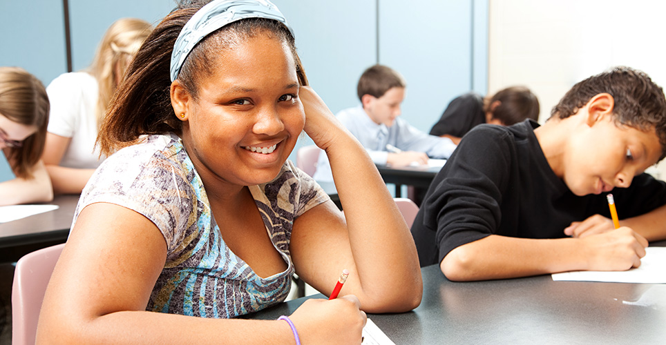 student smiling in class at school