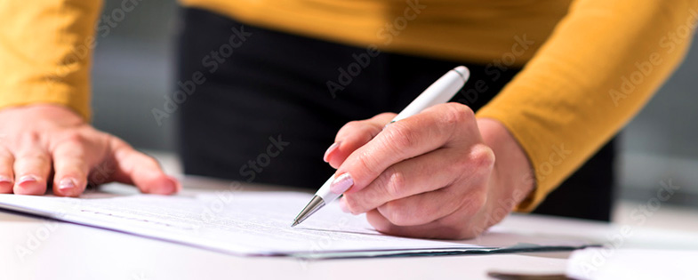 A person writing on a document
