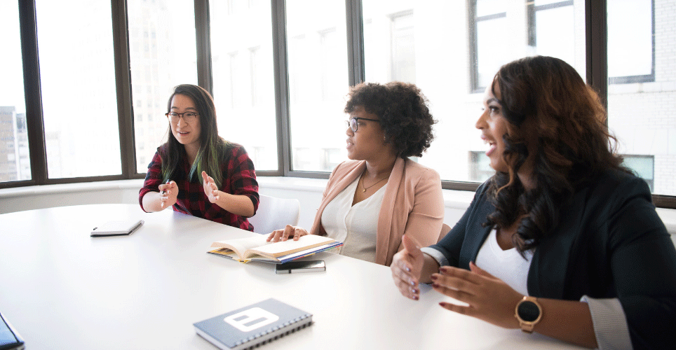 three women meeting at a table