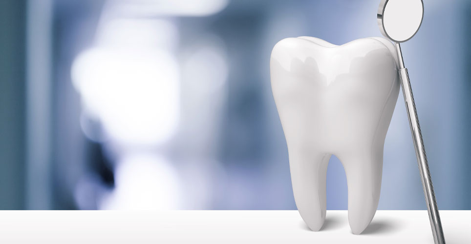 Close up of a white tooth and a dental tool against a blurred blue and white background.