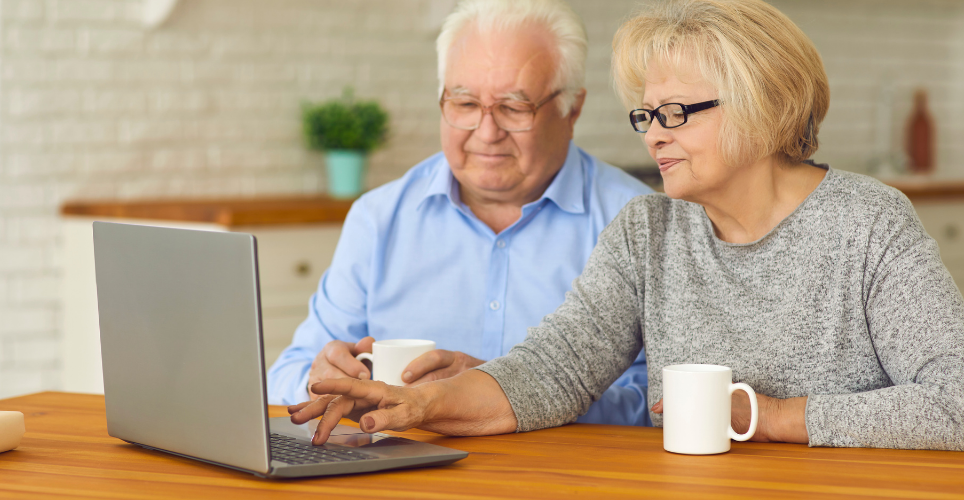 elderly couple chatting on on computer 