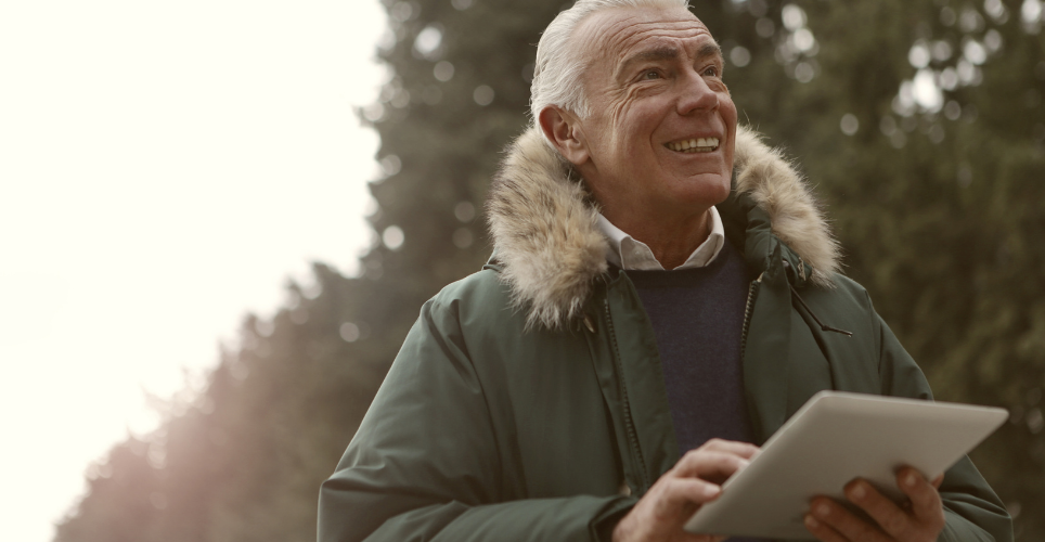 Man outdoors with tablet