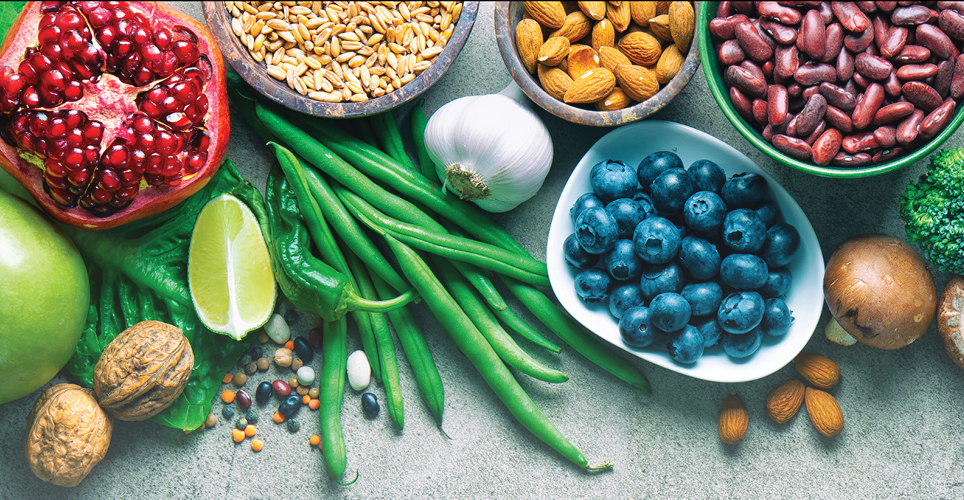 an array of fresh fruits and vegetables, whole grains, nuts and beans